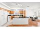 Bright kitchen includes an island, white appliances, and adjacent breakfast area at 5704 Owl Butte Ct, Las Vegas, NV 89149