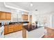 Bright kitchen with granite countertops, wood cabinets and a center island at 5704 Owl Butte Ct, Las Vegas, NV 89149
