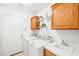 Functional laundry room with washer, dryer, sink, and built in cabinets at 5704 Owl Butte Ct, Las Vegas, NV 89149
