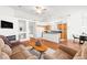 Open concept living space with fireplace, adjacent kitchen and dining area at 5704 Owl Butte Ct, Las Vegas, NV 89149