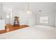Spacious living room with vaulted ceilings, neutral carpet and hardwood, and ample natural light at 5704 Owl Butte Ct, Las Vegas, NV 89149