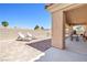 Outdoor patio featuring lounge chairs and a covered dining area, perfect for relaxation and entertaining at 5704 Owl Butte Ct, Las Vegas, NV 89149