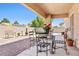 Inviting covered patio with a table and chairs, perfect for enjoying the outdoors at 5704 Owl Butte Ct, Las Vegas, NV 89149