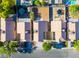 Aerial view of neighborhood homes, showcasing the roofs, driveways, backyards, and mature trees at 5984 Emerald Canyon Dr, Las Vegas, NV 89142