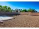 Spacious backyard with a stone surface and a stone perimeter wall at 5984 Emerald Canyon Dr, Las Vegas, NV 89142