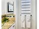 Stylish bathroom with tiled backsplash, granite countertop, and decorative towels at 5984 Emerald Canyon Dr, Las Vegas, NV 89142