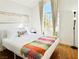 Bedroom with bed featuring cozy blanket, large window, and decor at 5984 Emerald Canyon Dr, Las Vegas, NV 89142