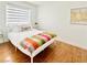 Bright bedroom featuring a bed with a colorful pillow and lots of natural light at 5984 Emerald Canyon Dr, Las Vegas, NV 89142