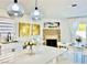 An open-concept dining room adjacent to the kitchen, featuring contemporary decor and fireplace at 5984 Emerald Canyon Dr, Las Vegas, NV 89142