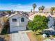 Charming two-story home with an attached garage, large driveway, mature tree and landscaping at 5984 Emerald Canyon Dr, Las Vegas, NV 89142