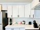 A modern, bright kitchen with stainless steel appliances, white cabinets and countertops at 5984 Emerald Canyon Dr, Las Vegas, NV 89142