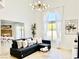 Bright and airy living room with large windows, comfortable seating, and modern lighting fixture at 5984 Emerald Canyon Dr, Las Vegas, NV 89142