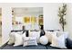 Open concept living room leading to the dining room and kitchen with modern decor and plants at 5984 Emerald Canyon Dr, Las Vegas, NV 89142