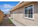 Exterior view of the home's backyard featuring a window, walkway, and perimeter fence at 600 Federal St, Henderson, NV 89015