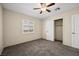 Bedroom with neutral walls, ceiling fan, closet, and carpeted floor at 600 Federal St, Henderson, NV 89015