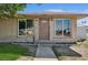 Close up of single story home with tidy lawn and well maintained curb appeal at 600 Federal St, Henderson, NV 89015