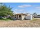 Charming single-story home with front lawn, mature tree, and detached storage shed at 600 Federal St, Henderson, NV 89015