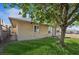 One-story home with manicured lawn, mature tree, and side access gate at 600 Federal St, Henderson, NV 89015