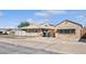 View of house and yard from across the street with a parked car at 600 Federal St, Henderson, NV 89015