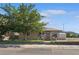 Charming home with a well-kept lawn, chain link fence, and mature tree at 600 Federal St, Henderson, NV 89015