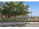 Cozy one-story home featuring a lush lawn and a mature shade tree at 600 Federal St, Henderson, NV 89015