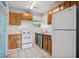 Compact kitchen featuring a white refrigerator, range, and window for natural light at 600 Federal St, Henderson, NV 89015