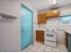 Functional kitchen features a white range, wood cabinets, and durable tile flooring at 600 Federal St, Henderson, NV 89015