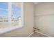 Bright laundry room featuring a window with natural light and wall-mounted shelves at 600 Federal St, Henderson, NV 89015