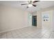 This living room features tile floors, a ceiling fan, closet shelves, and a window at 600 Federal St, Henderson, NV 89015