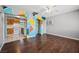 Open living area with hardwood floors, ceiling fan, and views into kitchen at 600 Federal St, Henderson, NV 89015