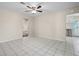 Open living room with tile floors, ceiling fan, and an adjacent room with tile floors and a stainless steel dishwasher at 600 Federal St, Henderson, NV 89015