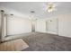 Bright living room with neutral carpet and ceilings fans at 600 Federal St, Henderson, NV 89015