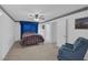 Bedroom with comfortable armchair, bed with plaid comforter, and access to the ensuite bathroom at 6804 Elm Creek Dr # 202, Las Vegas, NV 89108