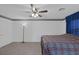 Bright bedroom with a large ceiling fan, carpet, and a comfortable bed with a patterned comforter at 6804 Elm Creek Dr # 202, Las Vegas, NV 89108