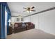 Bedroom with neutral carpet, two couches, blue accents, and wall-to-wall mirror at 6804 Elm Creek Dr # 202, Las Vegas, NV 89108