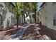 Exterior view showing buildings with a walkway in a community with mature trees and landscaping at 6804 Elm Creek Dr # 202, Las Vegas, NV 89108