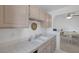 Kitchen with double sink, neutral tile, and view into the dining and living areas at 6804 Elm Creek Dr # 202, Las Vegas, NV 89108
