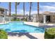Community swimming pool with clear blue water, palm trees, and nearby buildings at 6804 Elm Creek Dr # 202, Las Vegas, NV 89108