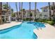 Outdoor pool with palm trees, poolside lounge chairs, and residential buildings in the background at 6804 Elm Creek Dr # 202, Las Vegas, NV 89108