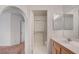 Bathroom with enclosed shower and single sink vanity with wooden cabinets at 7232 Vista Bonita Dr, Las Vegas, NV 89149