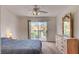 Bedroom with sliding glass doors to an outdoor balcony and dresser with mirror at 7232 Vista Bonita Dr, Las Vegas, NV 89149