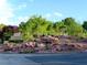 Scenic community entrance sign amidst desert landscaping with a street sign at 7232 Vista Bonita Dr, Las Vegas, NV 89149