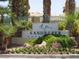 Elegant entrance sign for Sandpiper Golf community amidst lush greenery and palm trees at 7232 Vista Bonita Dr, Las Vegas, NV 89149