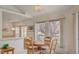 Bright dining area featuring large windows, a round wooden table, and access to other rooms at 7232 Vista Bonita Dr, Las Vegas, NV 89149
