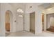 Bright entryway features an arched window, white tile floors, and a coat closet at 7232 Vista Bonita Dr, Las Vegas, NV 89149