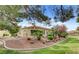 Charming single-story home with well-maintained desert landscaping and mature trees on a sunny day at 7232 Vista Bonita Dr, Las Vegas, NV 89149
