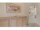 Hallway with custom wooden built in cabinets and decorative art piece at 7232 Vista Bonita Dr, Las Vegas, NV 89149