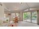 Bright living room with vaulted ceiling, a dining area, and sliding glass doors to a balcony at 7232 Vista Bonita Dr, Las Vegas, NV 89149