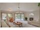 Cozy living room with fireplace, dining area, neutral carpeting, and natural light at 7232 Vista Bonita Dr, Las Vegas, NV 89149