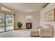 Comfortable living room featuring a fireplace, sliding glass door to a patio, and cozy armchair at 7232 Vista Bonita Dr, Las Vegas, NV 89149